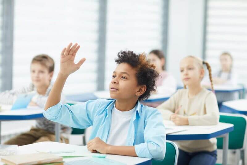 student raising his hand