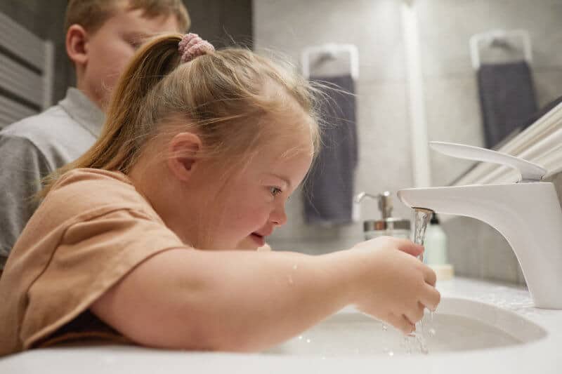 Child with Down Syndrome Washing Hands